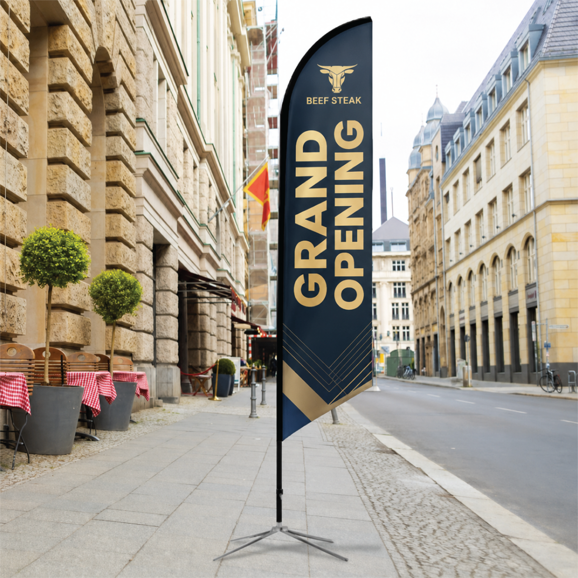 Beef Steak custom angled feather flag with black cross base displayed outdoors on a city street.