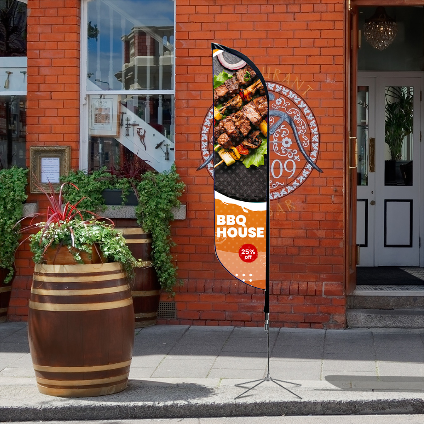 An orange promotional feather flag with food graphics standing on a brick sidewalk next to a storefront.⁠