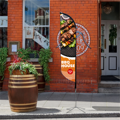 An orange promotional feather flag with food graphics standing on a brick sidewalk next to a storefront.⁠