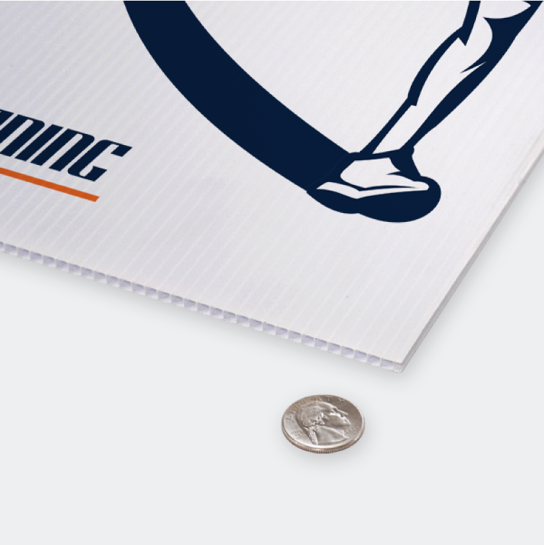 Close-up shot of a corrugated plastic yard sign with a quarter to illustrate the rigid fluted coroplast material thickness.⁠