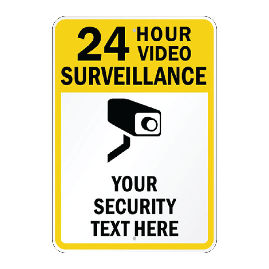 A rectangular yellow and white sign with rounded corners featuring the text '24 HOUR VIDEO SURVEILLANCE' in black, a black security camera icon, and 'YOUR SECURITY TEXT HERE' on a white background.