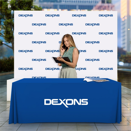 Custom blue 4-foot table throw with business logo paired with a white step and repeat backdrop.
