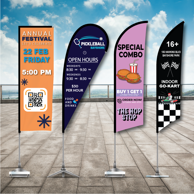 Four custom promotional advertising flags including a rectangular annual festival flag, a blue pickleball teardrop flag, a pink special combo feather flag, and a black checkered indoor go-kart flag displayed on an outdoor patio.
