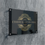Premium black acrylic business plaque with gold logo on a stone wall