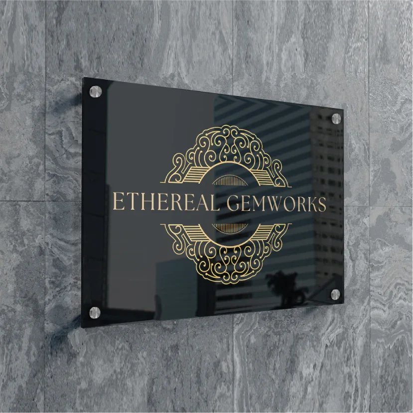 Premium black acrylic business plaque with gold logo on a stone wall