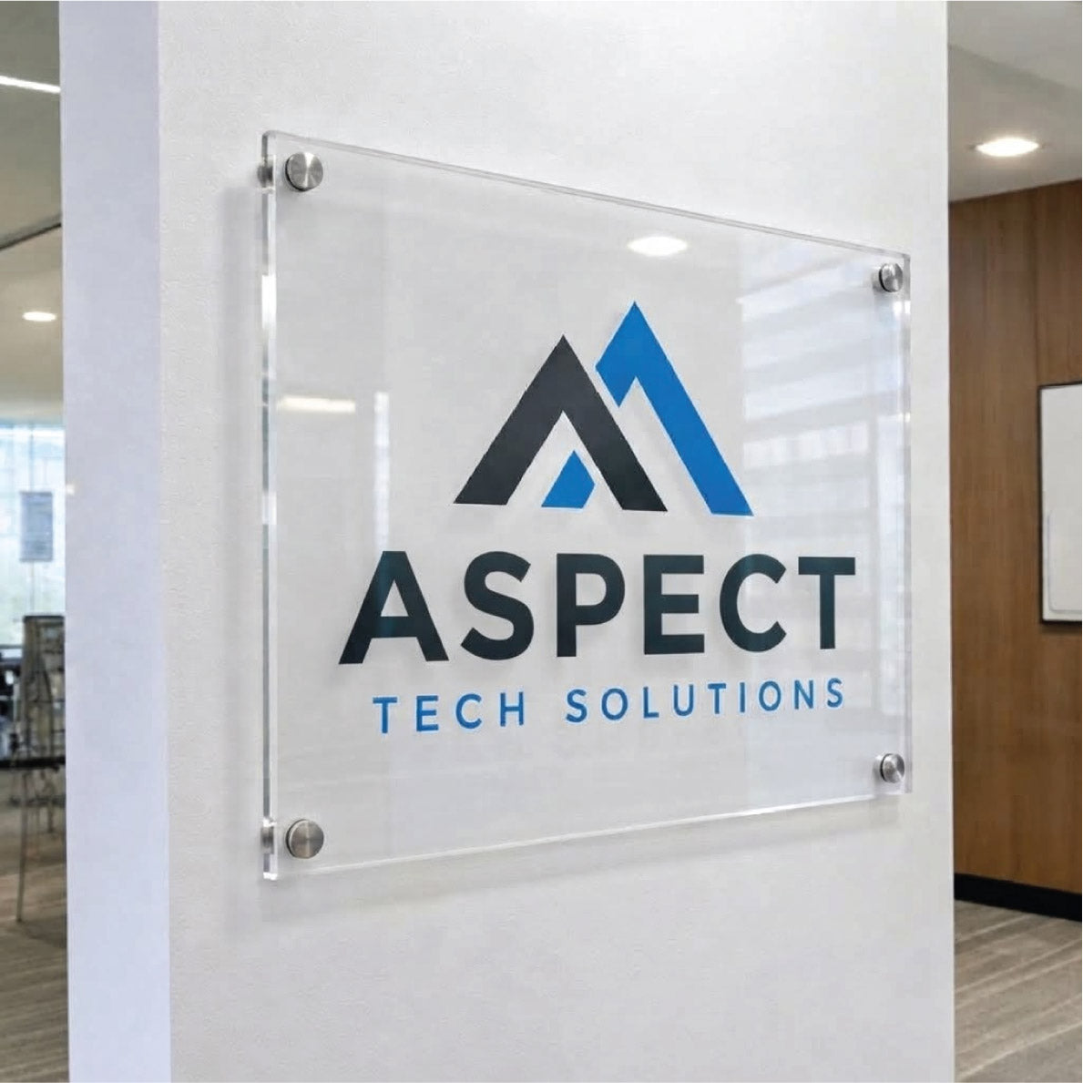 Custom clear acrylic wall-mounted office sign featuring the blue and black logo for Aspect Tech Solutions mounted with silver standoffs.