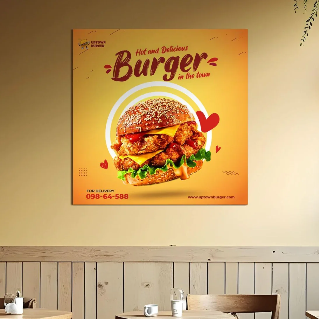 Square custom PVC sign featuring a vibrant burger graphic mounted on a restaurant wall above the seating area.⁠