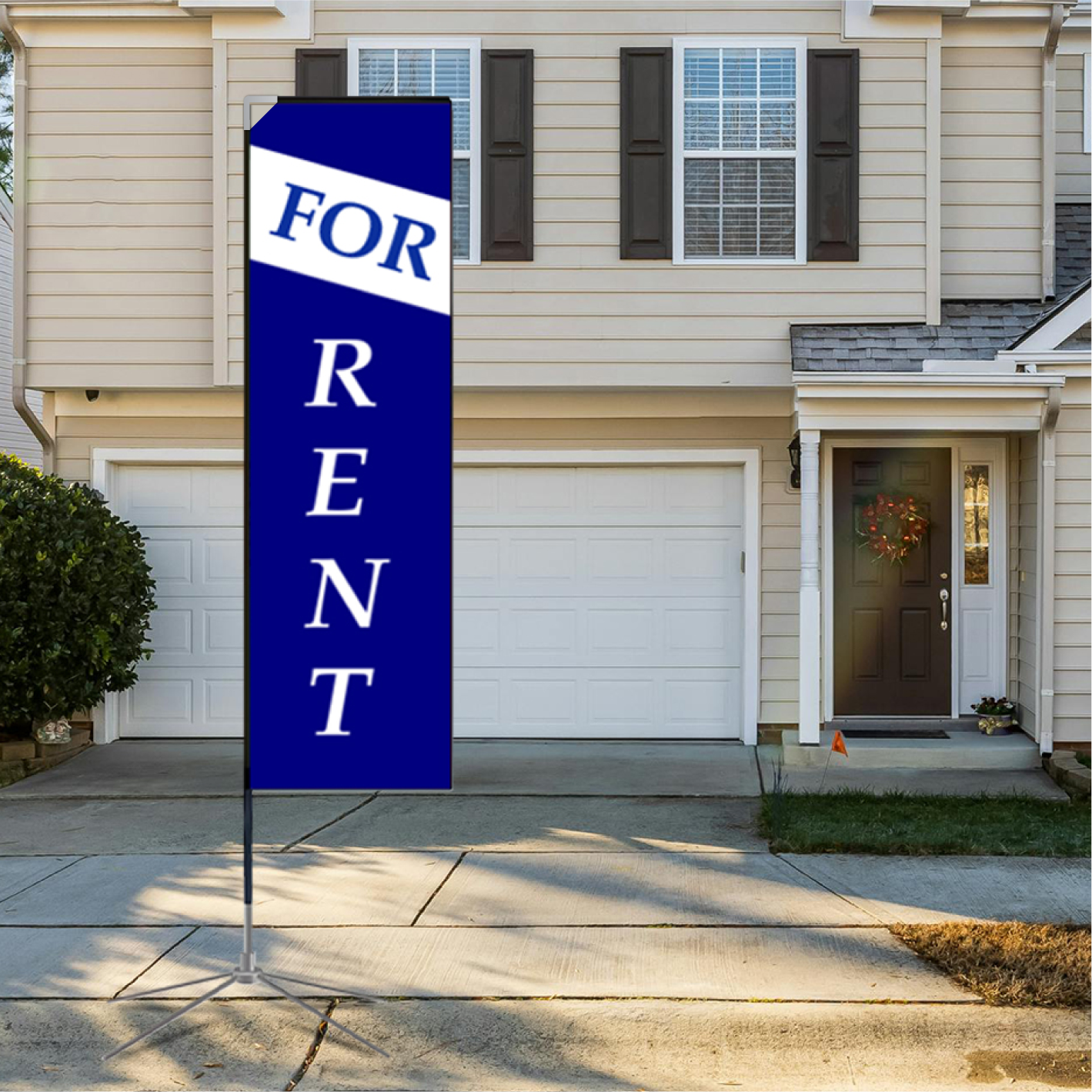 A tall blue rectangle advertising flag with white "For Rent" text standing on a residential driveway next to a house garage.