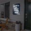 Custom dark blue reflective aluminum sign reading Welcome to the Wilson Family Patio in elegant white script, mounted outdoors on a home's siding next to a doorway.