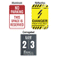 Three custom sign material options side-by-side: a red Aluminum No Parking sign, a yellow Reflective Aluminum High Voltage Danger sign, and a grey Corrugated Plastic parking lot sign.