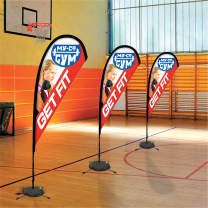 Orange custom teardrop flag banners reading Get Fit standing on an indoor basketball court gym floor.⁠