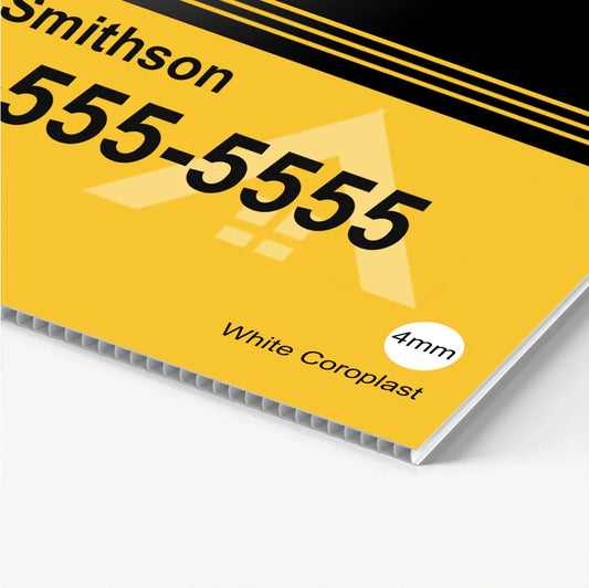 Close up of a custom yellow corrugated plastic yard sign with black text and fluted ridges.