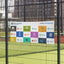 A white multi-logo corporate sponsor vinyl banner attached cleanly to a chain-link sports field fence.⁠