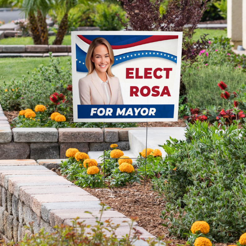 An Elect Rosa for Mayor political campaign yard sign placed in an outdoor garden landscape next to flowers.⁠
