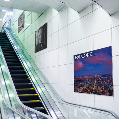 Multiple custom printed PVC Sintra board signs mounted for advertising along a commercial tiled wall next to an escalator.⁠