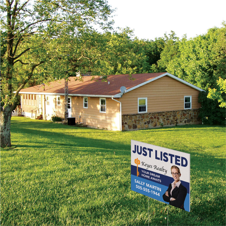 A blue Just Listed real estate coroplast lawn sign standing on the grass field of a single-story ranch home.⁠