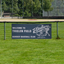 A blue custom sports sponsorship vinyl banner reading Welcome to Thielen Field mounted to an outfield baseball field fence.⁠