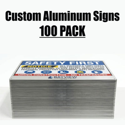 A stack of custom aluminum safety signs with a 'SAFETY FIRST' sign on top, shown against a white background with the text 'Custom Aluminum Signs 100 PACK' above it.